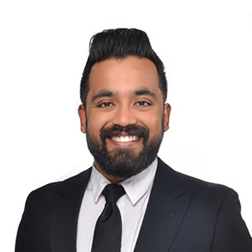 Headshot of a smiling man wearing a suit and tie.