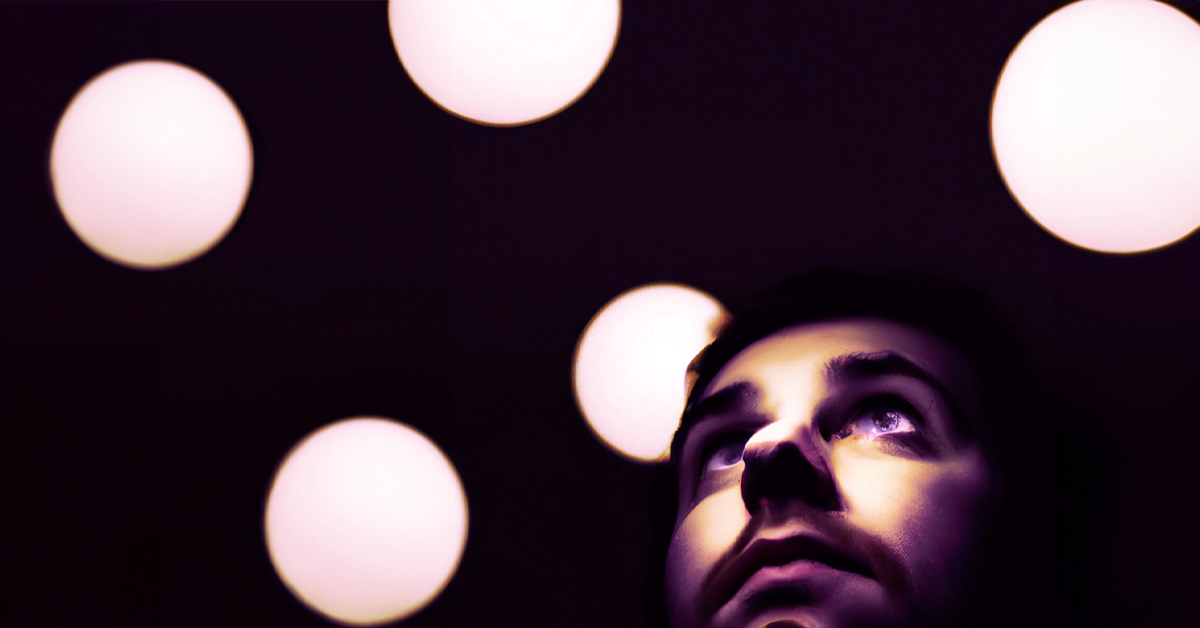 Image shooting up of a series of white dots and an close-up image of a bearded man looking outward.